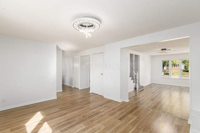 empty room featuring ceiling fan, a textured ceiling, and hardwood / wood-style flooring