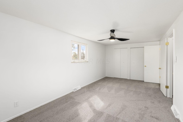 unfurnished bedroom with ceiling fan and light carpet