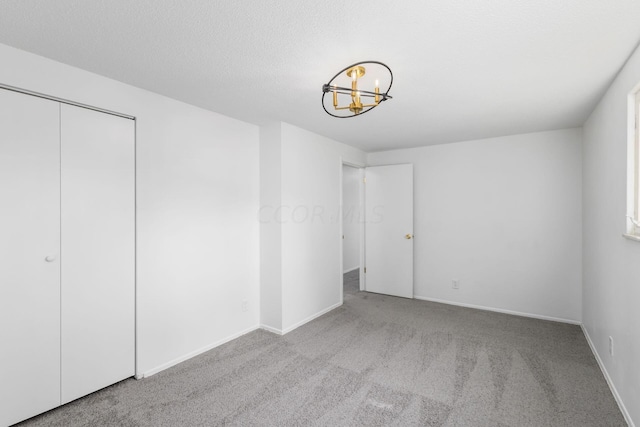 unfurnished bedroom with light carpet and a closet