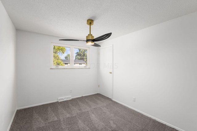 carpeted spare room with ceiling fan and a textured ceiling