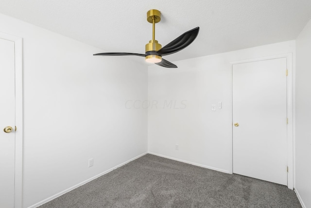 carpeted spare room with ceiling fan and a textured ceiling