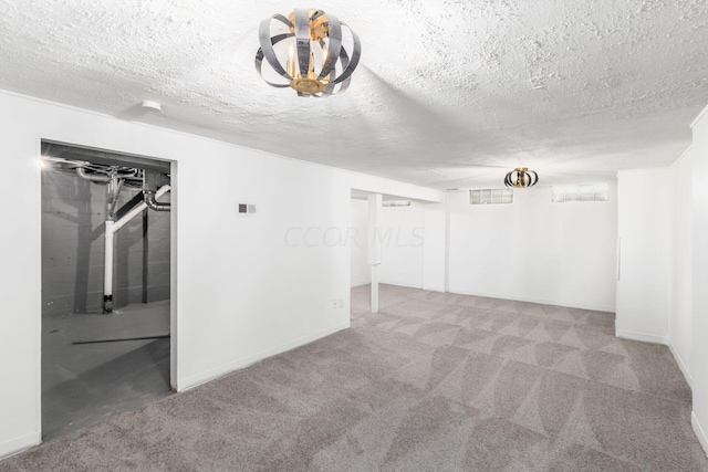 unfurnished room with carpet flooring and a textured ceiling