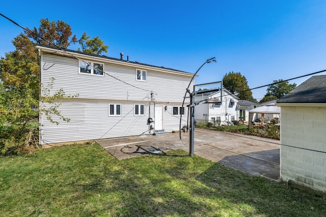 rear view of property with a lawn and a patio