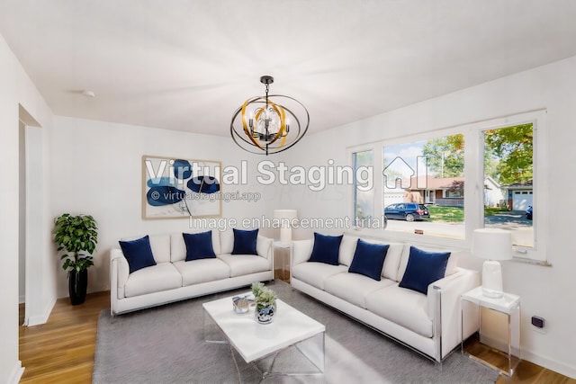 living room with hardwood / wood-style floors and a notable chandelier