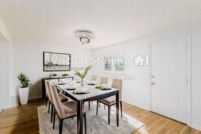 dining area with wood-type flooring