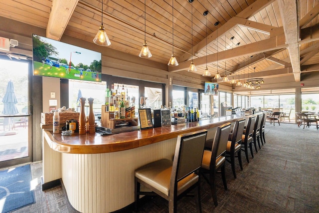 bar with dark colored carpet, pendant lighting, wood ceiling, and beamed ceiling