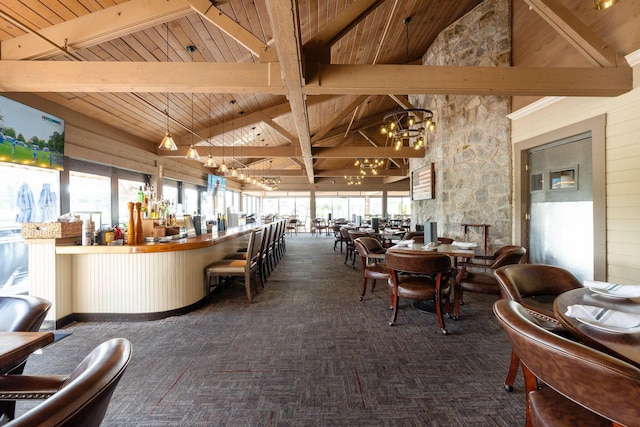 carpeted dining room featuring wooden ceiling, high vaulted ceiling, wooden walls, a notable chandelier, and beam ceiling