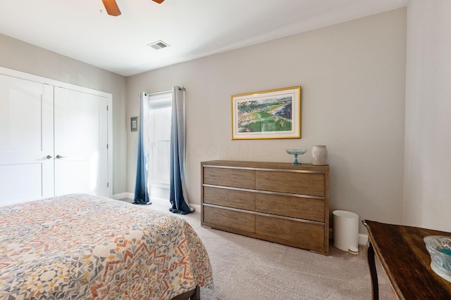 carpeted bedroom with ceiling fan and a closet