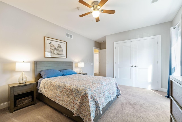 carpeted bedroom featuring ceiling fan and a closet