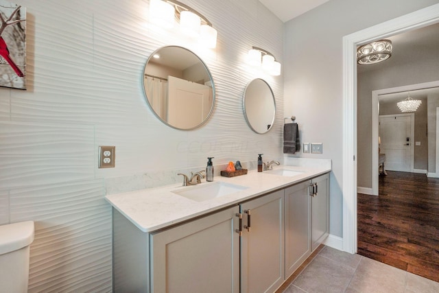 bathroom with hardwood / wood-style floors, vanity, and toilet