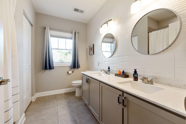 bathroom featuring tile patterned floors, vanity, and toilet