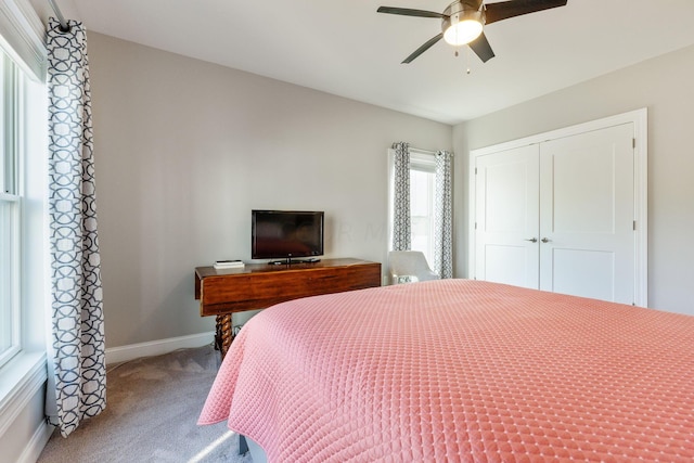 bedroom featuring ceiling fan, a closet, and carpet