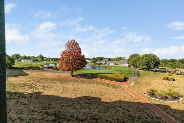 view of community with a lawn and a water view