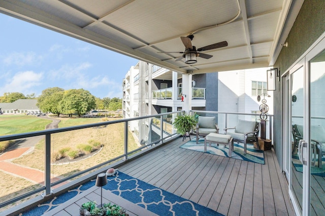 wooden deck featuring ceiling fan