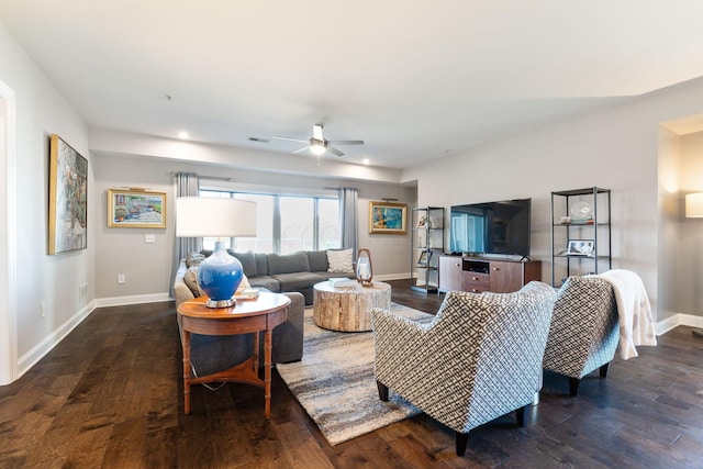 living room featuring ceiling fan and dark hardwood / wood-style flooring