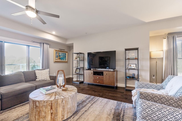 living room featuring ceiling fan and dark hardwood / wood-style flooring