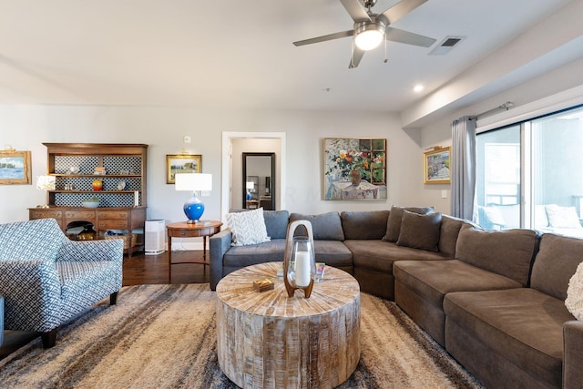 living room featuring ceiling fan and hardwood / wood-style flooring