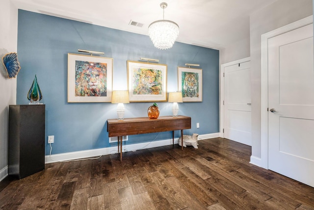 interior space with dark hardwood / wood-style floors and a chandelier