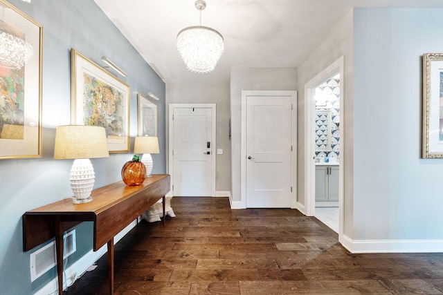 interior space with a notable chandelier and dark hardwood / wood-style floors