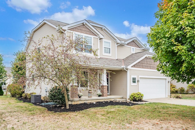 view of front of home featuring a porch, a garage, and a front lawn