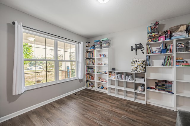 interior space with plenty of natural light and dark wood-type flooring