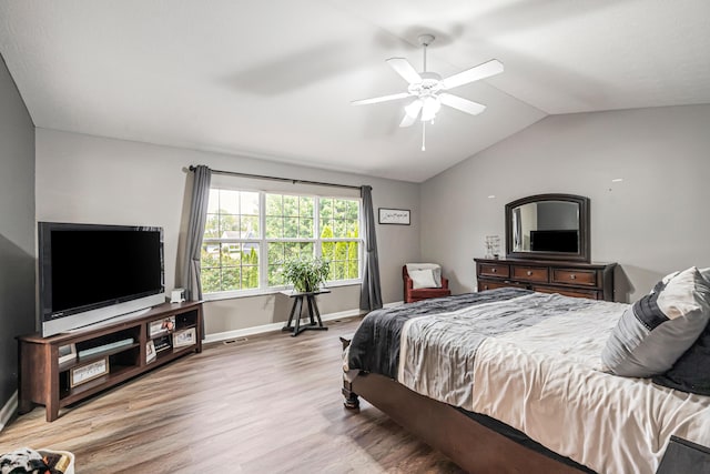 bedroom featuring hardwood / wood-style floors, ceiling fan, and vaulted ceiling