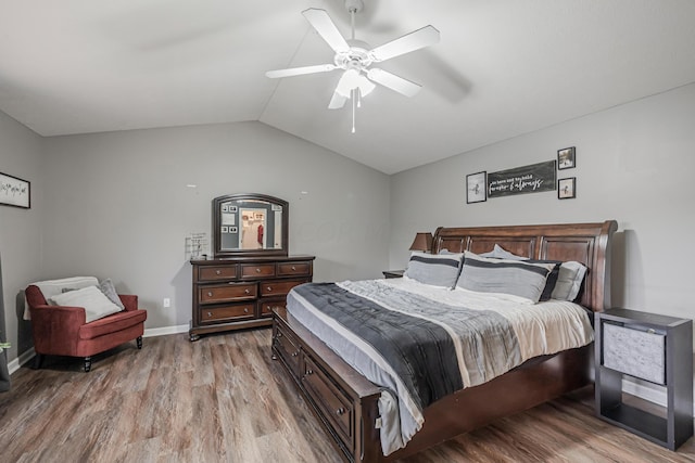 bedroom with hardwood / wood-style flooring, ceiling fan, and lofted ceiling