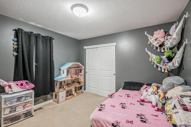 carpeted bedroom with a textured ceiling