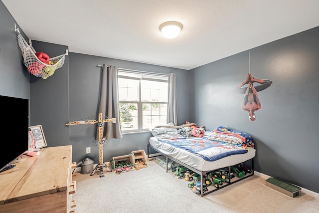 carpeted bedroom featuring a textured ceiling