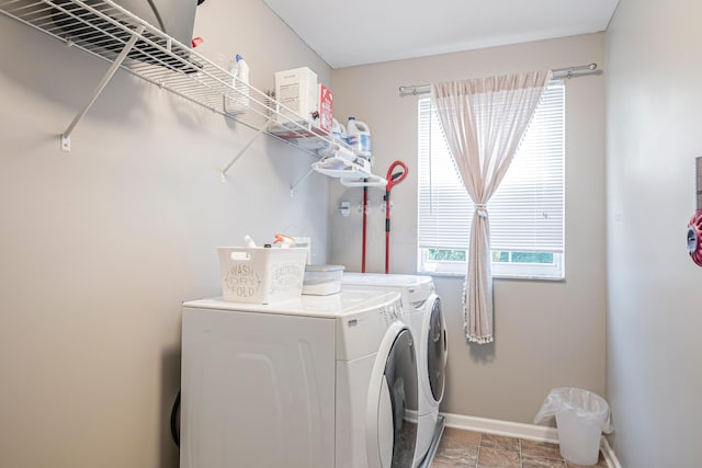 washroom with plenty of natural light and washing machine and clothes dryer