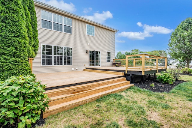 rear view of property featuring a deck