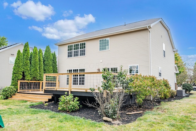 back of house featuring a wooden deck, a yard, and central AC unit