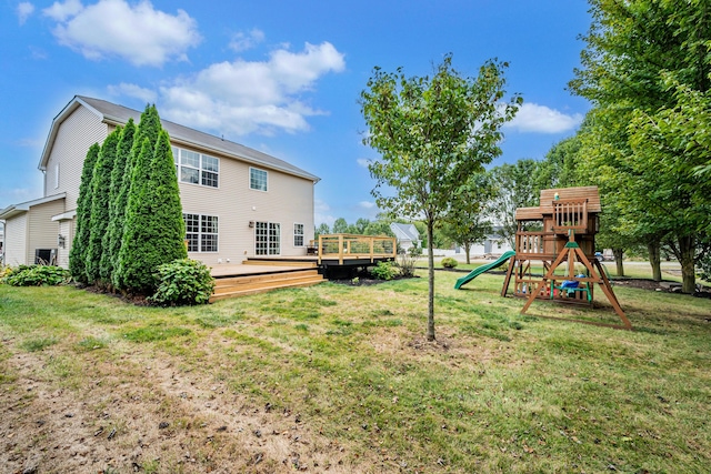 view of yard featuring a playground and a deck