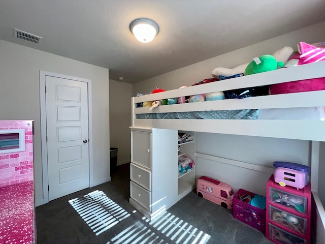 bedroom with dark colored carpet