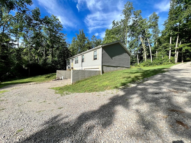 view of side of home featuring a lawn