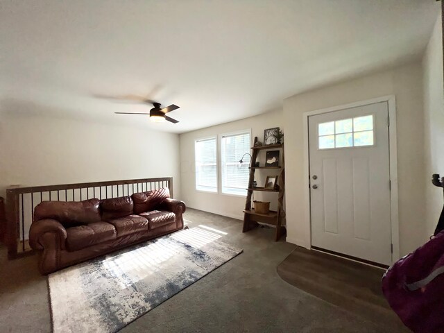 living room with ceiling fan and dark carpet