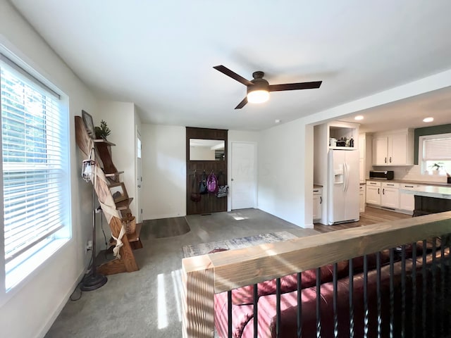 living room featuring ceiling fan and concrete floors