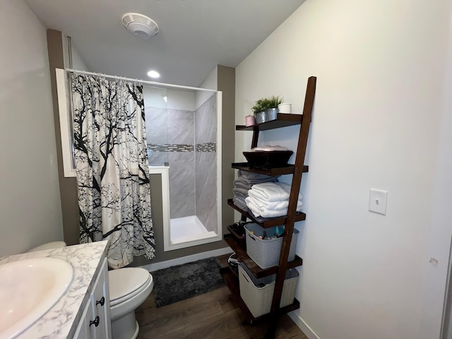 bathroom with a shower with shower curtain, wood-type flooring, vanity, and toilet