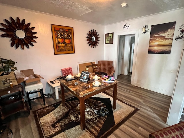 office space with a textured ceiling, dark hardwood / wood-style floors, and ornamental molding