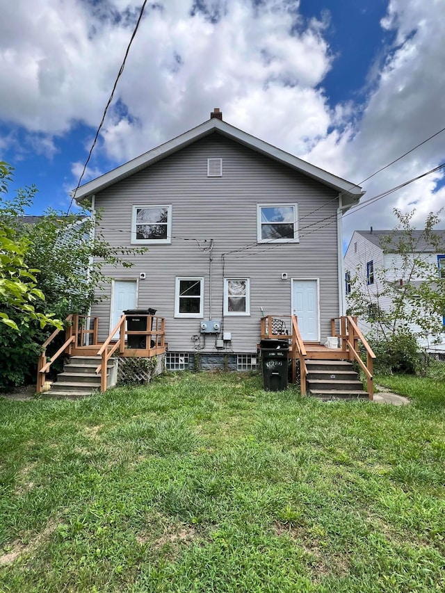 back of property featuring a lawn