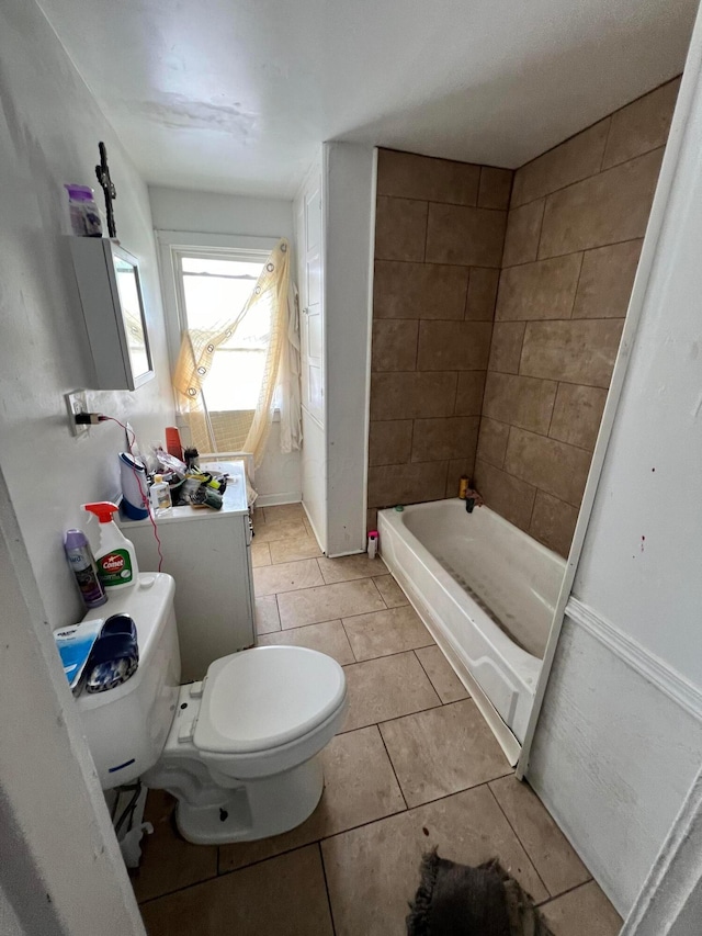 bathroom featuring a tub, tile patterned flooring, and toilet