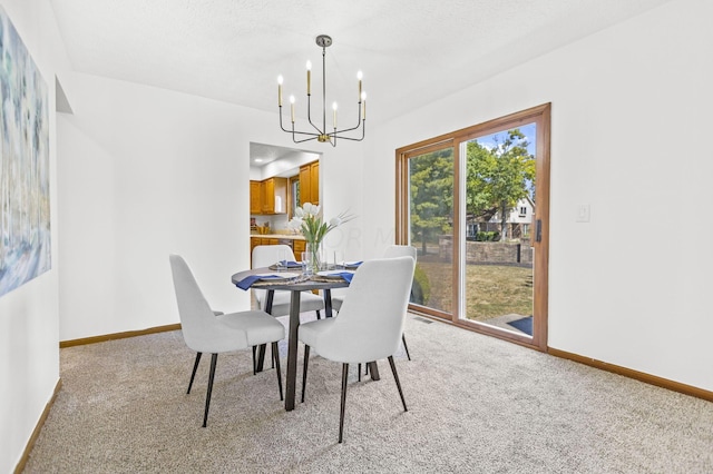 dining room featuring a textured ceiling, light colored carpet, and a notable chandelier