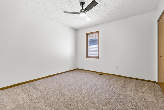 unfurnished room with carpet flooring, ceiling fan, and a textured ceiling