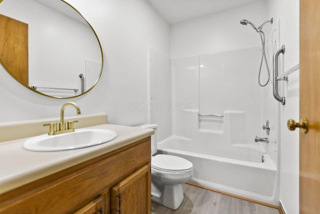 full bathroom featuring vanity, wood-type flooring, bathtub / shower combination, and toilet