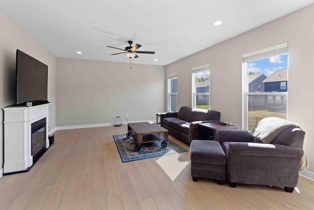 living room featuring ceiling fan and light hardwood / wood-style flooring