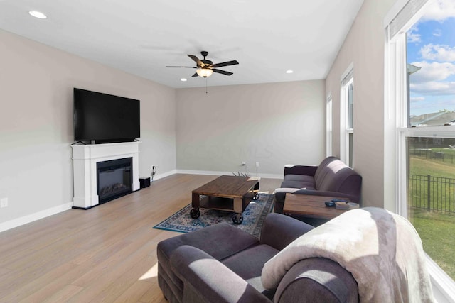 living room featuring light hardwood / wood-style floors and ceiling fan