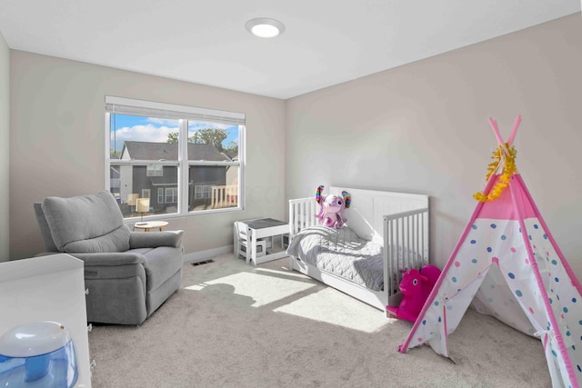 bedroom featuring light colored carpet