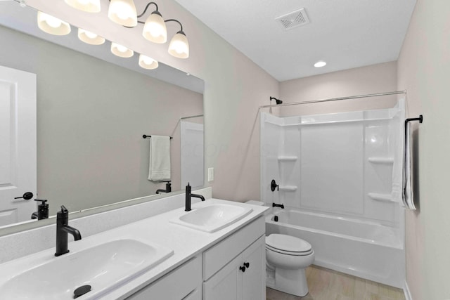 full bathroom with wood-type flooring, vanity, toilet, and shower / bathtub combination