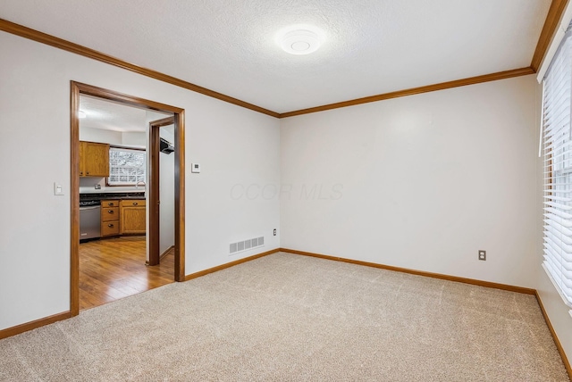 interior space with crown molding, light colored carpet, and a textured ceiling