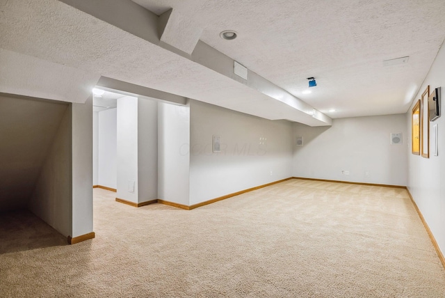 basement featuring carpet flooring and a textured ceiling